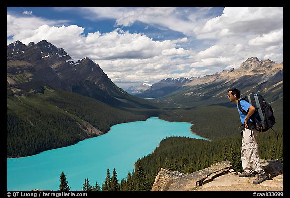 Hiker wearing backpack looking at Peyto Lake. Banff National Park, Canadian Rockies, Alberta, Canada (color)