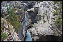 Narrow slot cut in limestone rock by river, Mistaya Canyon. Banff National Park, Canadian Rockies, Alberta, Canada (color)
