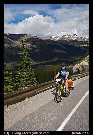 Woman cyclist, Icefieds Parkway. Jasper National Park, Canadian Rockies, Alberta, Canada (color)