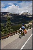 Woman cyclist, Icefieds Parkway. Jasper National Park, Canadian Rockies, Alberta, Canada (color)