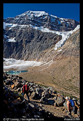 Hikers on trail below the face of Mt Edith Cavell. Jasper National Park, Canadian Rockies, Alberta, Canada