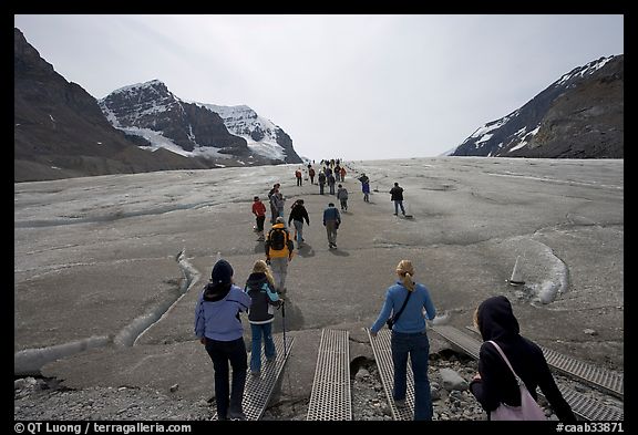 Tourists walking onto  Athabasca Glacier. Jasper National Park, Canadian Rockies, Alberta, Canada