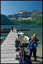 Couple preparing to scuba dive, Cameron Lake. Waterton Lakes National Park, Alberta, Canada ( color)