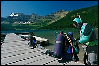 Scuba divers preparing to dive into cold waters of Cameron Lake. Waterton Lakes National Park, Alberta, Canada (color)
