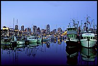 Fishing boats and skyline at dusk. Vancouver, British Columbia, Canada