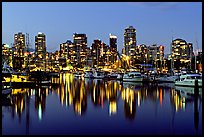 Fishing boats and skyline light reflected at night. Vancouver, British Columbia, Canada (color)