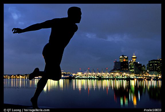 Harry Jerome (a former great sprinter)  statue and Harbor at night. Vancouver, British Columbia, Canada