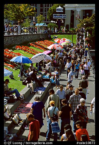 Tourists and art exhibitors on the quay of inner harbour. Victoria, British Columbia, Canada (color)