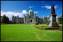 Lawn, statue of Queen Victoria for whom the city was named, and parliament. Victoria, British Columbia, Canada