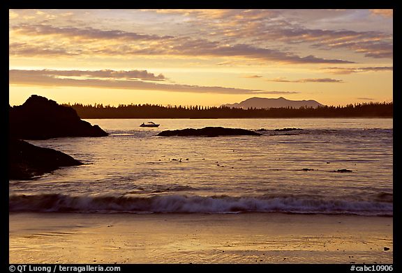 Marine landscape with a small boat in a distance, sunset. Pacific Rim National Park, Vancouver Island, British Columbia, Canada