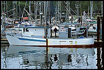 Fishing boat and reflections in harbor, Uclulet. Vancouver Island, British Columbia, Canada ( color)
