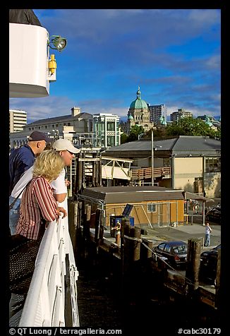Passengers standing on the deck of the ferry, as it sails into the Inner Harbor. Victoria, British Columbia, Canada