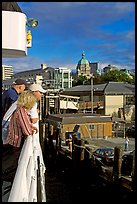 Passengers standing on the deck of the ferry, as it sails into the Inner Harbor. Victoria, British Columbia, Canada ( color)