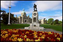 Flowers, memorial, and parliament building. Victoria, British Columbia, Canada ( color)