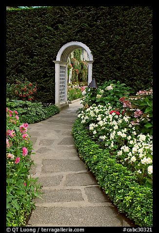 Arched entrance  leading to the Italian Garden. Butchart Gardens, Victoria, British Columbia, Canada (color)