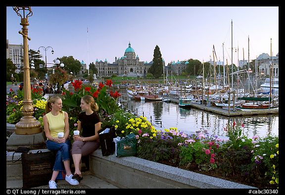 Young Women sitting, Inner harbor. Victoria, British Columbia, Canada