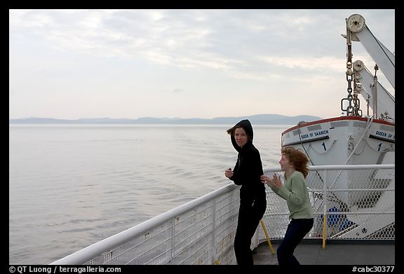 Woman and girl looking out from deck of ferry. Vancouver Island, British Columbia, Canada (color)