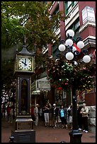 Tourists watch steam clock in Water Street. Vancouver, British Columbia, Canada