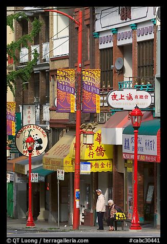 Street in Chinatown with red lamp posts and Chinese script. Vancouver, British Columbia, Canada (color)