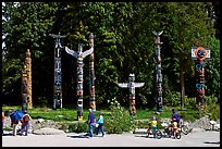 Tourists loooking at Totems, Stanley Park. Vancouver, British Columbia, Canada ( color)