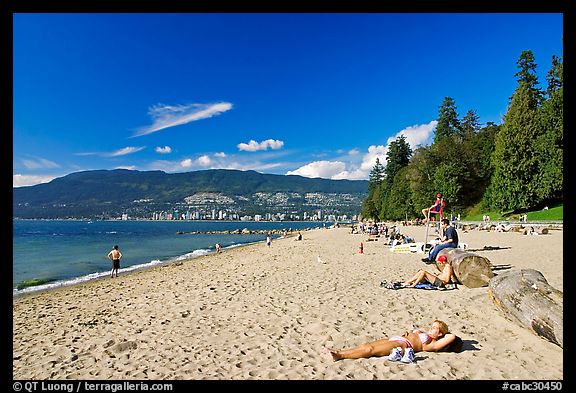 Woman sunning herself on a beach, Stanley Park. Vancouver, British Columbia, Canada