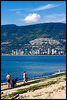 Family near the water on a beach, Stanley Park. Vancouver, British Columbia, Canada (color)