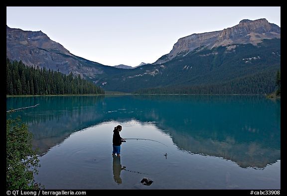 Picture/Photo: Woman fishing in Emerald Lake, sunset. Yoho National Park,  Canadian Rockies, British Columbia, Canada