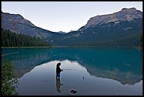 Woman fishing in Emerald Lake, sunset. Yoho National Park, Canadian Rockies, British Columbia, Canada (color)