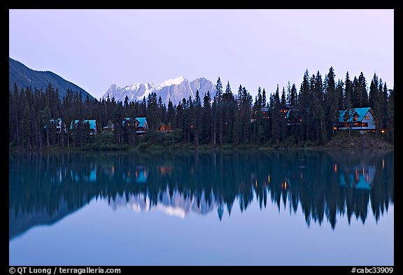 Trees and cabins reflected in Emerald Lake, dusk. Yoho National Park, Canadian Rockies, British Columbia, Canada