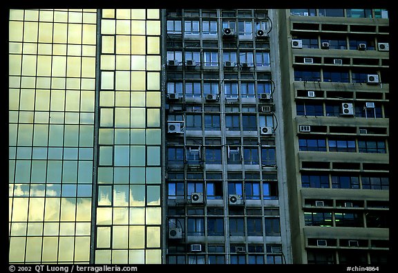 Glass building next to older buildings with air conditioners, Hong-Kong Island. Hong-Kong, China