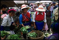 Bai women buying vegetables at the Monday market. Shaping, Yunnan, China (color)