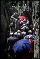 Crowds of Chinese tourists in a walkway among the limestone pillars. Shilin, Yunnan, China ( color)