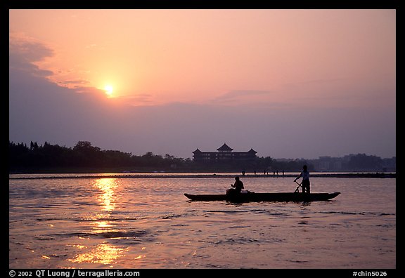 Fishermen at the confluence of the Dadu He and Min He rivers at sunset. Leshan, Sichuan, China (color)