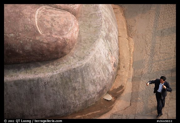 Man standing next to the toe of the Grand Buddha. Leshan, Sichuan, China (color)