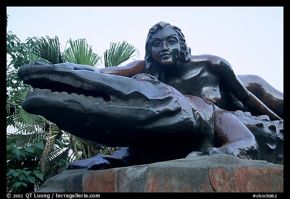Odd sculpure of a naked woman with a crocodile. Leshan, Sichuan, China (color)