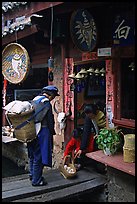 Naxi woman offers eggs for sale to local residents. Lijiang, Yunnan, China (color)