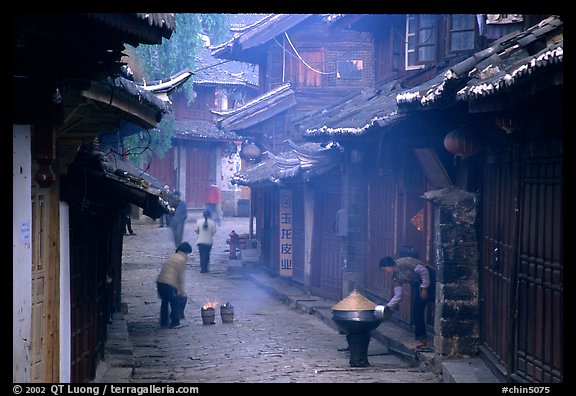 Street in the morning with dumplings being cooked. Lijiang, Yunnan, China