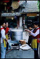 Naxi women selling dumplings and Naxi baba flatbread. Lijiang, Yunnan, China (color)