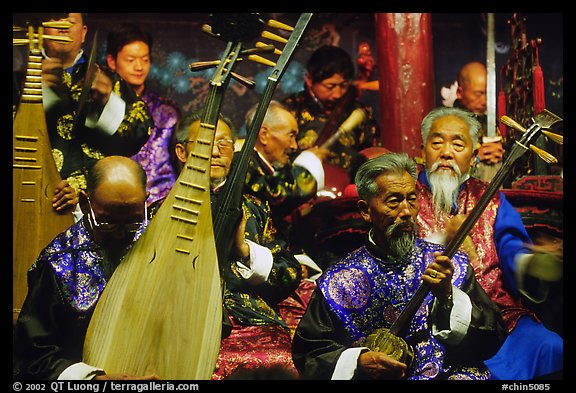 Elderly musicians of the Naxi Orchestra playing traditional instruments. Lijiang, Yunnan, China (color)