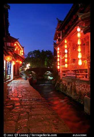 Cobblestone street and canal at night. Lijiang, Yunnan, China