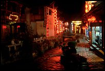 Red lanterns reflected in a canal at night. Lijiang, Yunnan, China ( color)