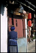 Naxi woman at the door of her wooden house. Lijiang, Yunnan, China ( color)