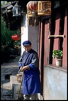 Naxi woman at the door of her wooden house. Lijiang, Yunnan, China ( color)