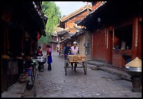 Early morning activity in a cobblestone street. Lijiang, Yunnan, China