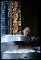 Woman baking dumplings. Lijiang, Yunnan, China ( color)