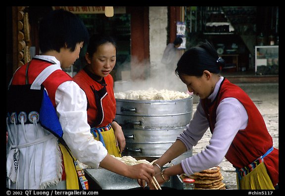 Naxi Women preparing the baba flatbreat. Lijiang, Yunnan, China (color)