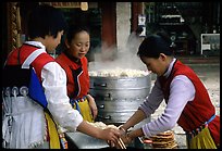 Naxi Women preparing the baba flatbreat. Lijiang, Yunnan, China ( color)