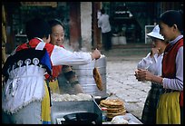 Naxi Women preparing the baba flatbreat. Lijiang, Yunnan, China ( color)