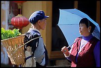 Two women conversing in the street. Lijiang, Yunnan, China (color)