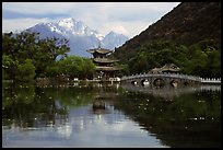 Pavillon and Jade Dragon Snow Mountains reflected in the Black Dragon Pool. Lijiang, Yunnan, China